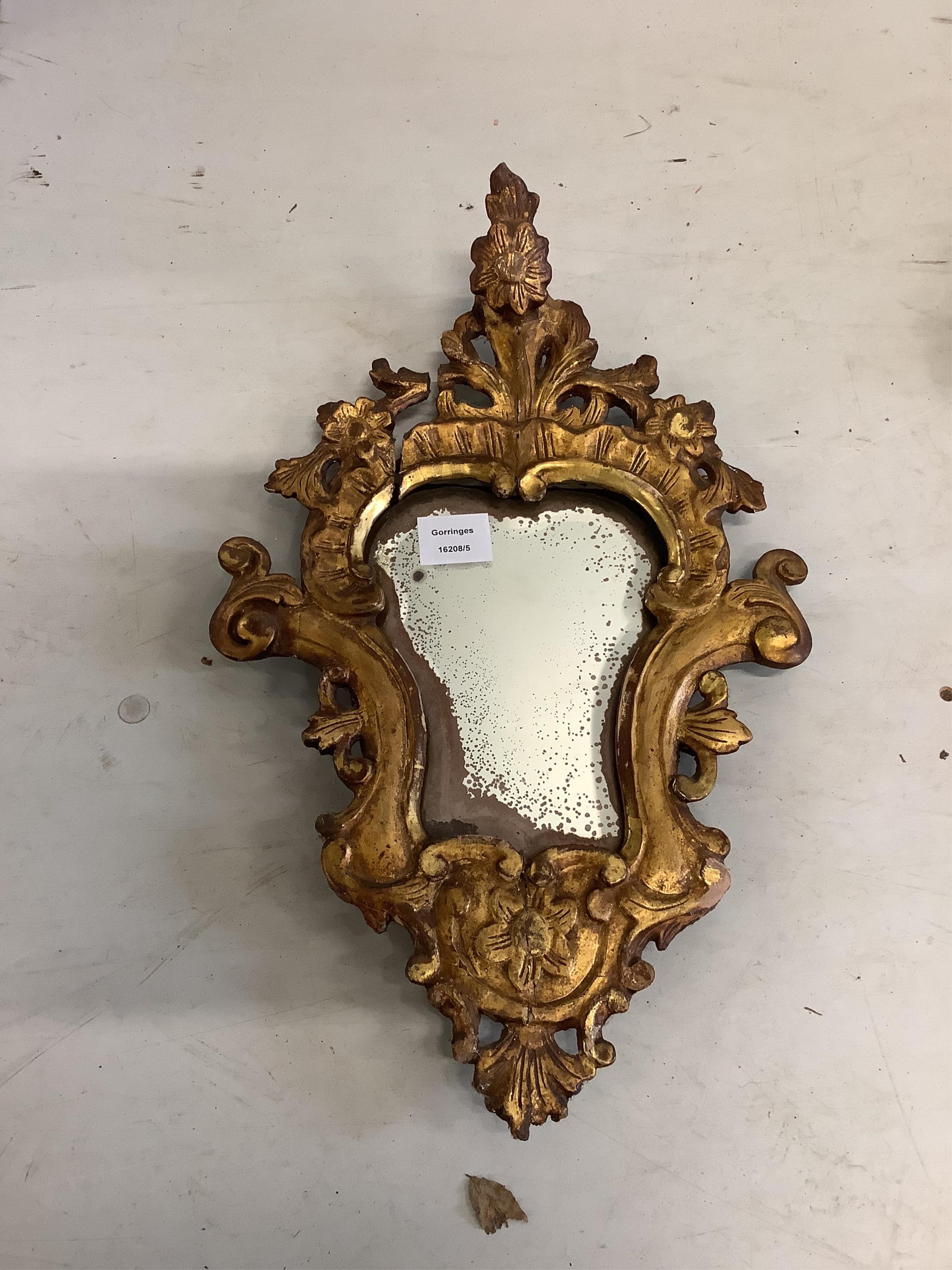 A pair of cartouche shaped carved giltwood wall mirrors, width 31cm, height 51cm. Condition - poor to fair